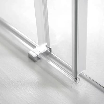 Close-up of chrome hardware and clear tempered glass panel base on an 8mm sliding shower door track