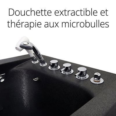 Gros plan sur les boutons de commande chromés et la douchette extractible sur le rebord d’une baignoire noire à porte avec système de microbulles