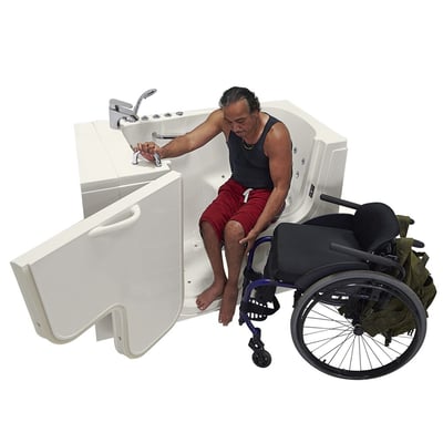 Person transferring from his chair into the Ella Transfer30 walk-in tub with wide outward-swing door open