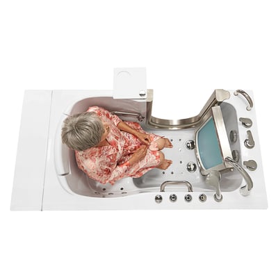 Overhead view of senior woman seated inside the Ella Elite walk-in tub 30x52 with hydrotherapy jets and stainless steel door open