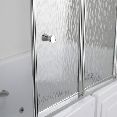 Partly folded tempered glass shower screen panels with a chrome knob, above the rim of a white walk in tub.