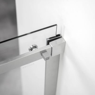 Primer plano del marco de acero inoxidable cepillado y los herrajes de abrazadera de vidrio en la puerta de ducha corredera de vidrio templado Ella Primo