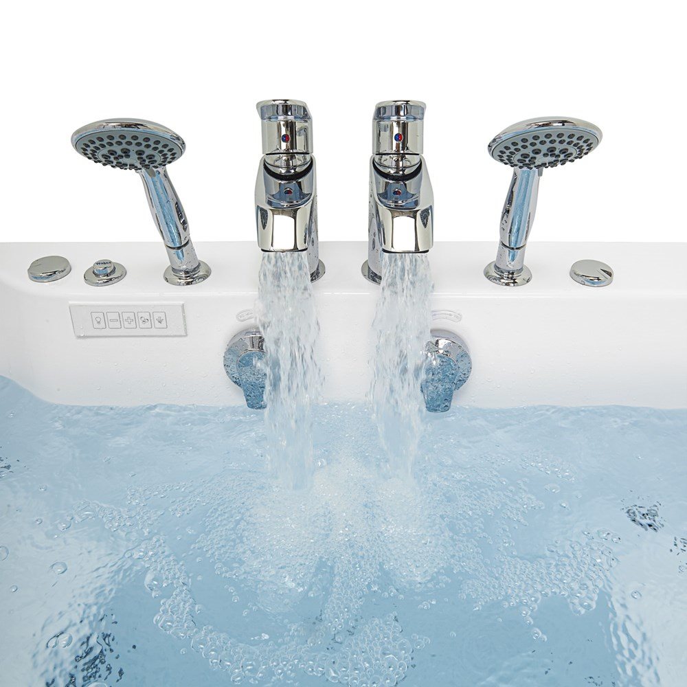 Close-up of the twin chrome faucets and two handheld showers filling the Ella Big4Two two-seat walk-in tub