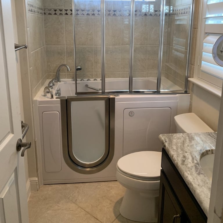 Ella walk-in tub with stainless steel outward swing door and glass shower enclosure installed in a beige tiled bathroom