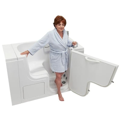 Senior woman in a blue robe standing inside an Ella walk-in tub with the outward swing door open showing low-step entry