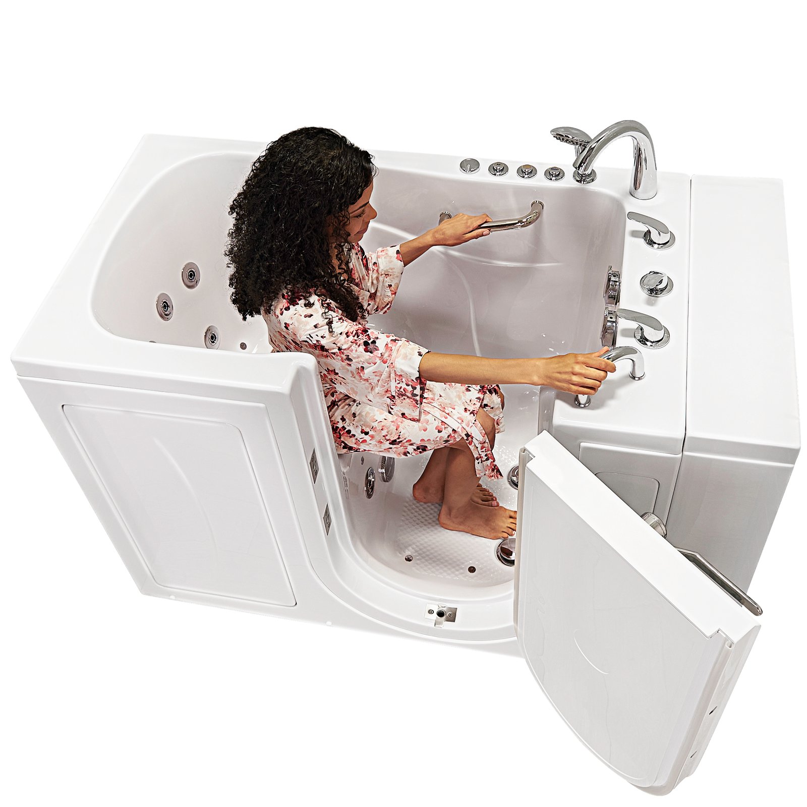 Woman seated inside an Ella Monaco walk-in tub with outward swing door open, holding the handheld showerhead and grab bar