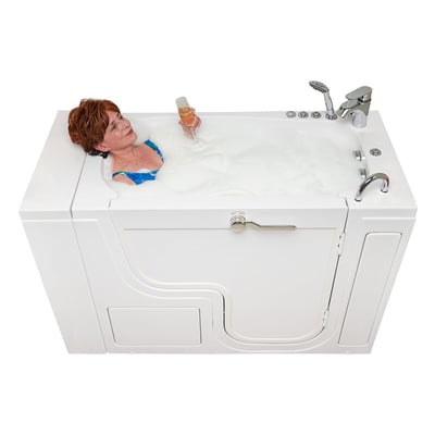 Senior woman relaxing with a champagne glass in the Ella Transfer 26 ADA accessible walk-in tub with hydro massage bubbles