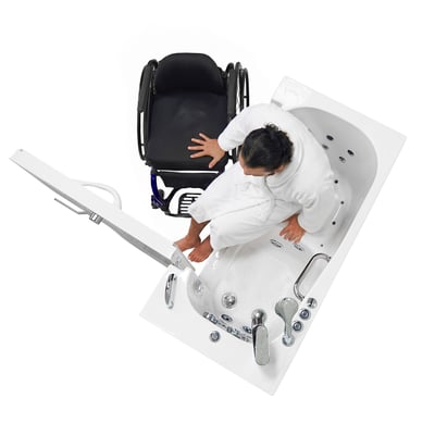 Overhead view of a man in a robe moving from his wheelchair into a walk-in tub beside him