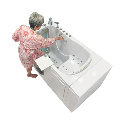 Senior woman in floral robe gripping the grab bar while stepping into the Ella Elite 30x52 walk-in tub with hydrotherapy jets