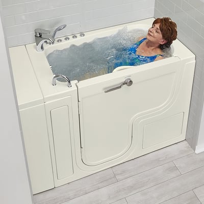 Senior woman relaxing with eyes closed enjoying a hydro massage soak in the Ella Transfer30 ADA accessible walk-in tub