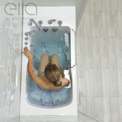 Overhead view of a woman soaking in the Ella Ultra Acrylic walk-in tub with hydro jets, fast fill faucet, and dual drain