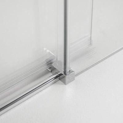 Close-up of chrome bottom track and corner connector on an 8mm tempered glass sliding shower door panel