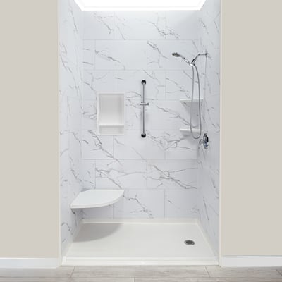 Ella's Bubbles accessible shower stall with marble acrylic walls, built-in soap niche, fold-down corner seat, and handheld showerhead