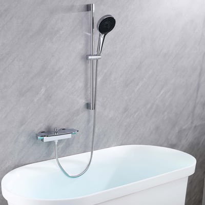 Chrome waterfall tub filler with adjustable slide bar and handheld shower wand mounted above a white walk-in tub