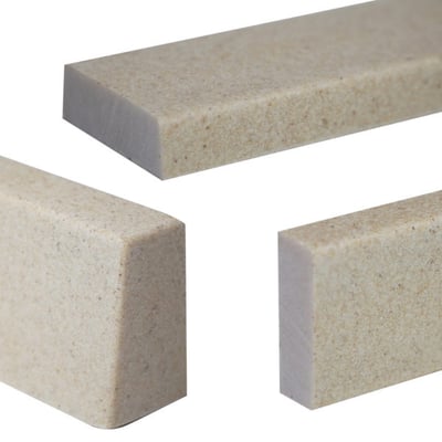 Close-up of three Ella travertine sandstone shower wall trim pieces in a 2x3/4x60 inch profile for accessible showers