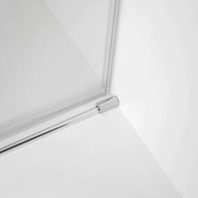 Close-up of chrome corner bracket and bottom rail on an 8mm tempered glass sliding shower door