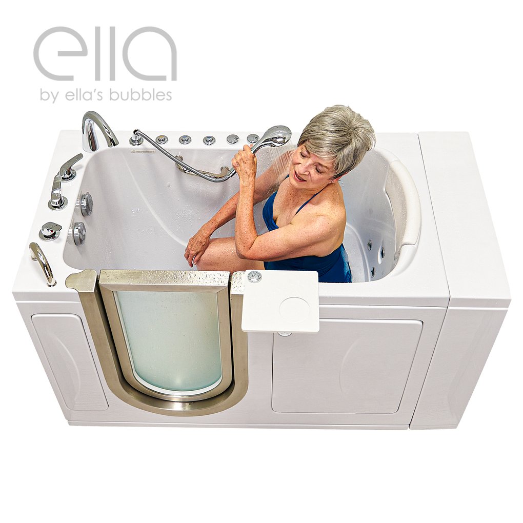 Senior woman using a handheld showerhead while seated inside the Ella Royal walk-in tub with dual jets and open door
