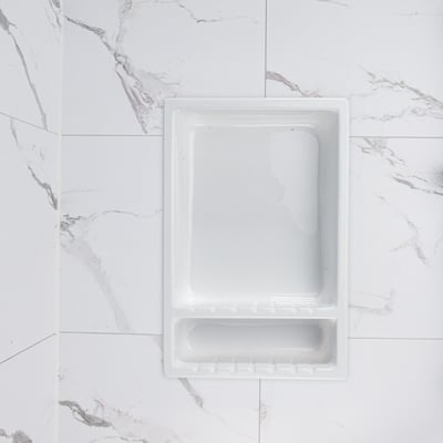 White acrylic recessed soap niche with built-in soap dish installed flush in a marble-look shower wall