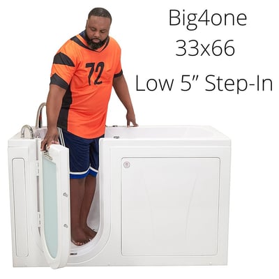 Man stepping into the Ella Big4one 33x66 walk-in tub through the open outward swing door with low 5-inch step-in entry