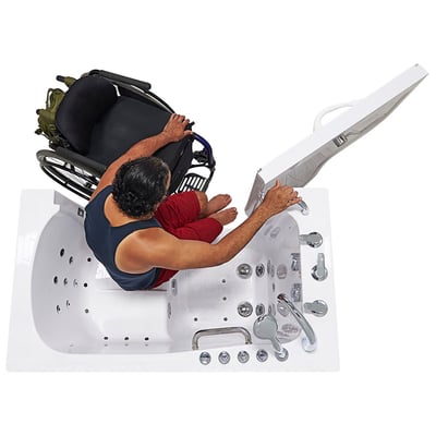 Wheelchair user transferring sideways into the Ella Transfer60 walk-in tub with outward swing door open, aerial top-down view