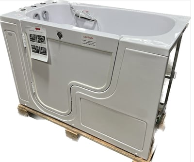Ella Transfer60 wheelchair accessible walk-in bathtub with outward swing door shown on shipping pallet, 30x60 inch white acrylic