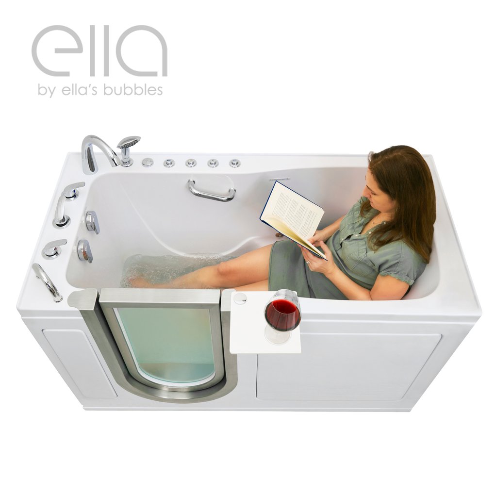 Woman relaxing and reading a book in an Ella Ultimate walk-in tub with a glass of red wine on the swivel tray