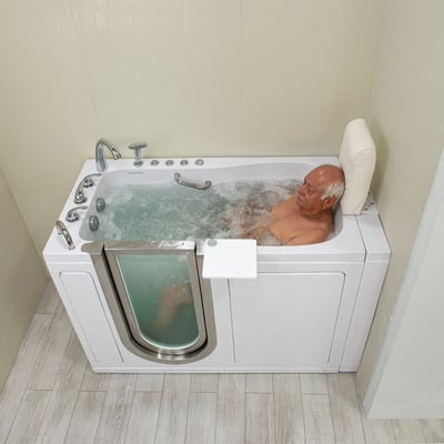 Senior man relaxing in an Ella walk-in tub with bubbling hydro massage jets and a removable padded headrest neck support