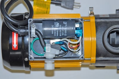 Close-up of Ella walk-in tub hydro pump motor with open cover showing internal wiring and capacitor components