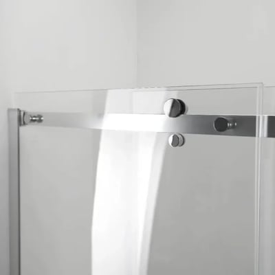 Close-up of chrome hardware and rollers on an 8mm tempered glass sliding shower door panel with frameless design