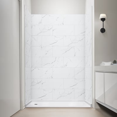 Walk-in accessible shower stall with Carrara white marble-look grout-free wall panels and low-threshold shower base
