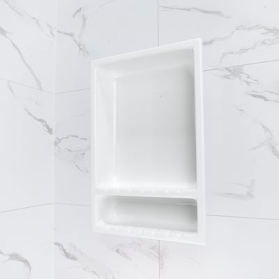Close-up of a white acrylic recessed soap niche with dual shelves mounted on marble-look shower wall panels