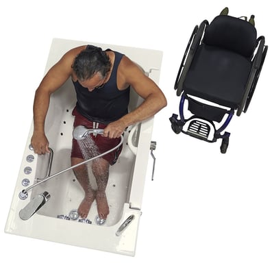 Person seated inside the Ella Transfer30 walk-in tub using a handheld showerhead, mobility aid parked alongside