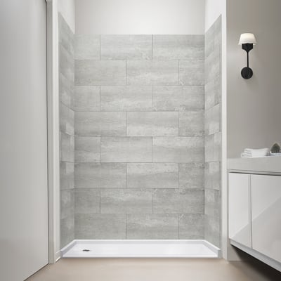 Ella accessible shower stall with brushed concrete tile-free wall panels and white low-threshold shower base