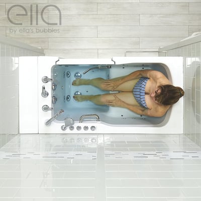 Overhead view of a woman relaxing in the Ella Ultra Acrylic walk-in tub showing hydro jets, dual drain, and chrome fixtures