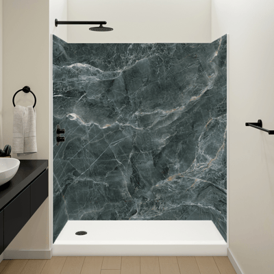 Walk-in shower stall with Verde Indio marble-look wall panels, white shower base, and matte black rain showerhead fixtures
