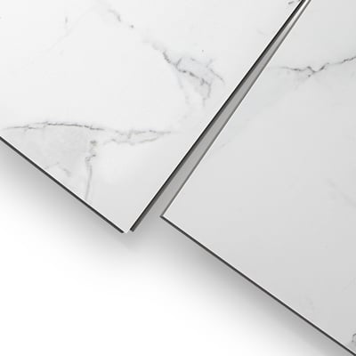 Close-up of two Carrara white marble-look wall panels with gray veining and grout-free smooth surface finish