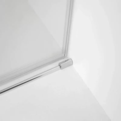 Close-up of chrome corner hinge and frame on an 8mm tempered glass sliding shower door with clean white surround
