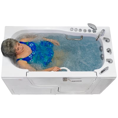 Senior woman relaxing in bubbling hydro massage jets inside the Ella Transfer60 wheelchair accessible walk-in tub with dual drain