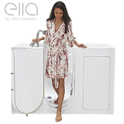 Woman in floral robe stepping into the Ella Capri walk-in tub through the wide outward swing door low-step entry