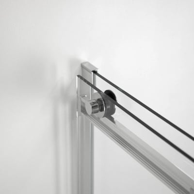 Close-up of chrome roller hardware and 8mm tempered glass sliding shower door track mounted to wall frame