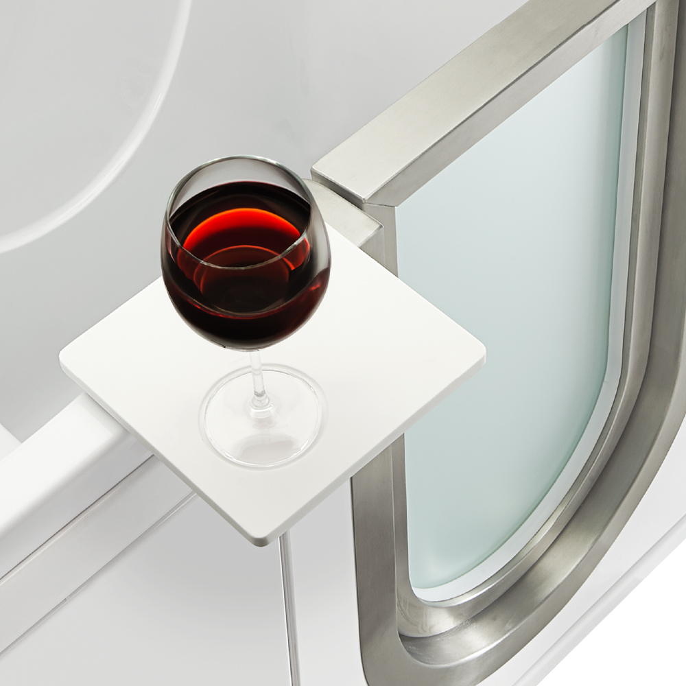Close-up of a red wine glass resting on the swivel tray of an Ella Elite walk-in tub beside the chrome door frame