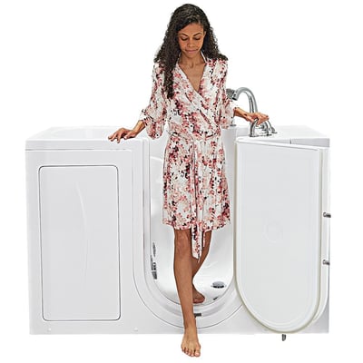 Woman in floral robe stepping through the open outward swing door of the Ella Capri walk-in tub with low-step entry