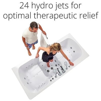 Woman stepping into the Ella Big4Two two-seat walk-in tub with 24 hydro jets while a man holds the outward swing door open