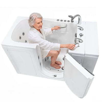 Senior woman seated in the Ella Capri walk in tub holding the grab bar, with the outswing door open beside her