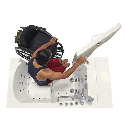 Person transferring from chair into the Ella Transfer30 walk-in tub with wide outward-swing door, aerial view