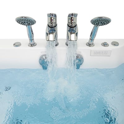 Close-up of dual chrome faucets filling a two-seat walk-in tub with handheld showerheads and control panel