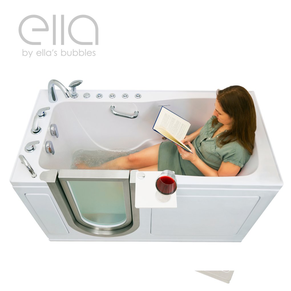 Woman relaxing and reading a book in the Ella Ultimate walk-in tub with a glass of red wine on the swivel tray