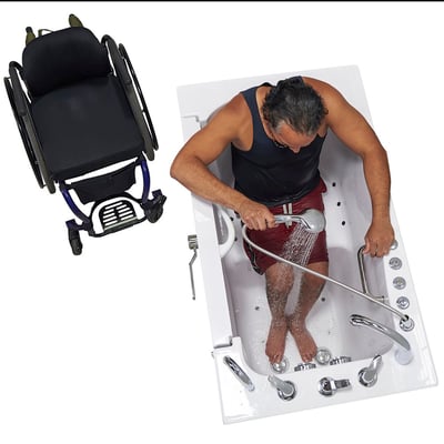 Man using a handheld shower wand inside the Ella Transfer60 wheelchair accessible walk-in tub with a wheelchair parked alongside