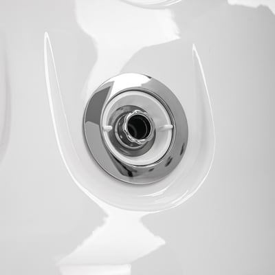 Macro of a single chrome hydrotherapy jet nozzle set into the white acrylic shell of a walk in tub.