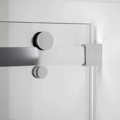 Close-up of chrome sliding hardware and round knobs on an 8mm tempered glass sliding shower door panel